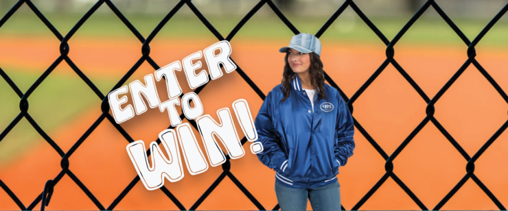 A photo of a person wearing a royal blue, satin team jacket with white strips on the cuffs, collar, and waist band, standing in front of a chain link fence. Overlaid on image are the words: Enter to Win