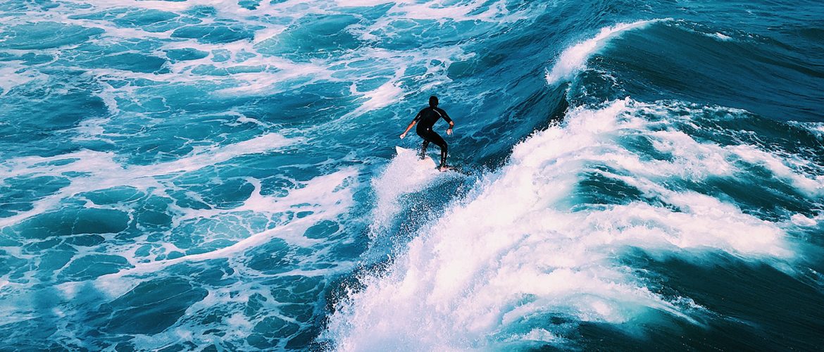 man surfing on ocean