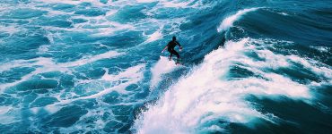man surfing on ocean