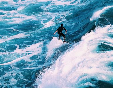 man surfing on ocean