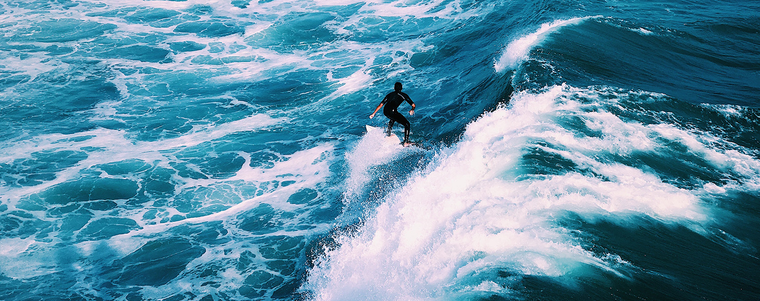 man surfing on ocean