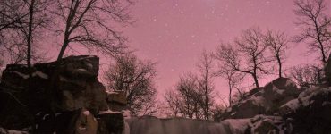 "Winnewissa Under Stars" (Winnewissa surrounded by a dusting of snow on the cliffs and a blanket of stars overhead). Credit: Pipestone National Monument (National Park Service), public domain.