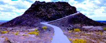 A small volcano cone with a paved trail leading up the perimeter.