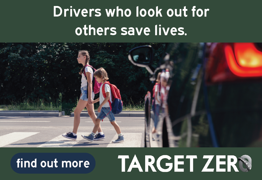 A green background with the words "Drivers who look out for others save lives, find out more TARGETZERO" along with a photo of two young people walking on a cross walk and a car stopped with a breaklight waiting for them to safely cross the street.
