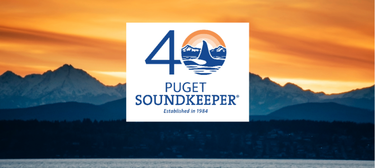 An image of an orange sunset over the Puget Sound with the number 40 with the fin of an orca in the "0" and the words "Puget SoundKeeper, established 1984"