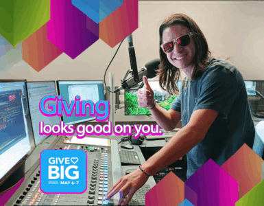 Person in a radio studio giving a thumbs up, with colorful graphics promoting the "Give Big" event scheduled for May 6-7, featuring the text "Giving looks good on you.