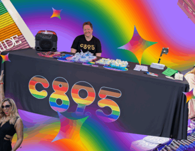 Promotional event for C895 at a Pride celebration, featuring a DJ booth, attendees spinning a prize wheel, and colorful decorations including rainbow motifs.