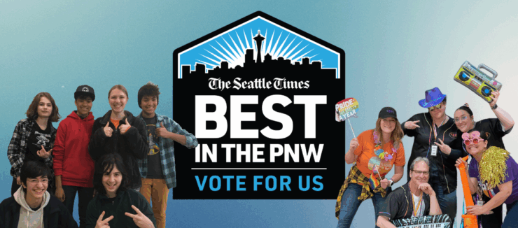Group of people smiling and posing playfully with props, encouraging votes for 'The Seattle Times' as 'Best in the PNW'. Prominent blue logo in the center with text.