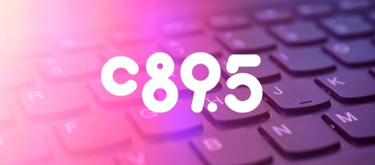 Close-up view of a keyboard with the letters and numbers 'C 8 9 . 5' highlighted in a glowing purple hue.