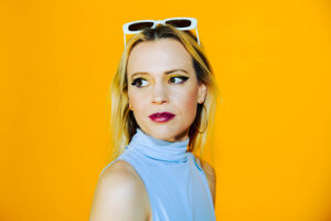 An image of Bexxie against a yellow background