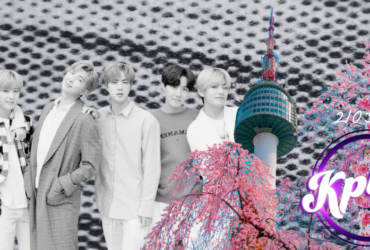 A group of people stand together with Namsan Tower in the background, surrounded by pink cherry blossoms. The text "Kplus" and "210325" is visible on the right side. The background features a pattern resembling a macro view of fabric.