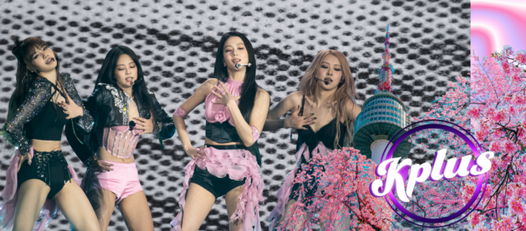 Four performers are on stage, dancing energetically against a black and white patterned backdrop. They wear stylish pink and black outfits. A graphic in the foreground features cherry blossoms and a tower, with the text "Kplus" inside a circle.