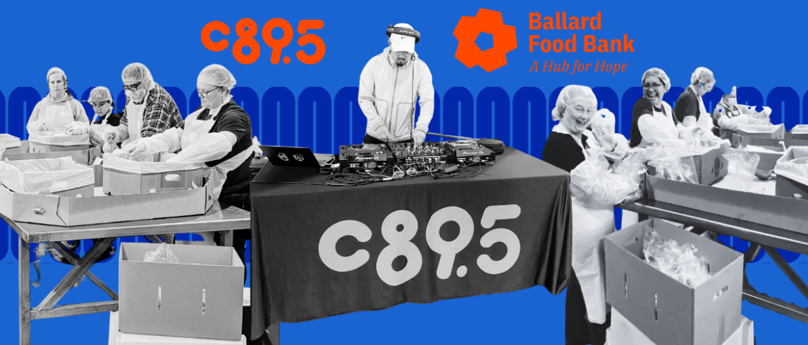 People wearing hairnets and aprons are packing items into boxes on long tables. A DJ is playing music at a station with a banner reading "C89.5." The background displays the logos for "C89.5" and "Ballard Food Bank: A Hub for Hope.