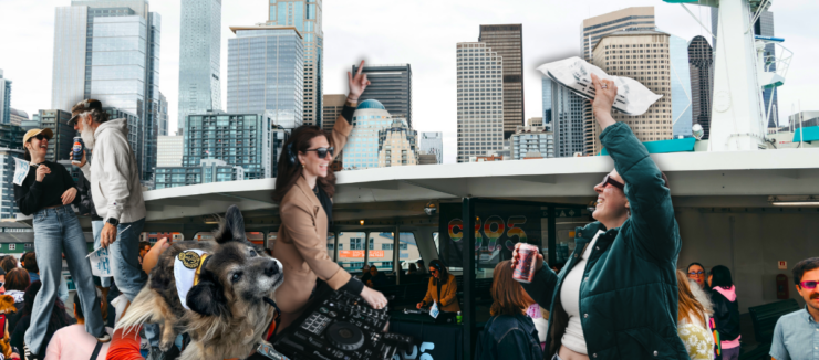 A crowded ferry deck with people taking photos and mingling, set against the backdrop of Seattle's skyline featuring tall buildings and landmarks. The top of the ferry's structure is visible, flying flags.