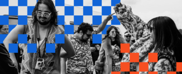 A group of people enjoy dancing with lively expressions. A person in the foreground wears large glasses and a camera around their neck. The image has a checkerboard overlay pattern in blue and orange squares.