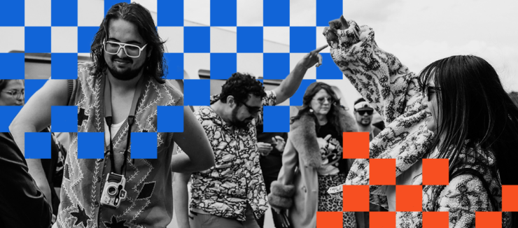 A group of people enjoy dancing with lively expressions. A person in the foreground wears large glasses and a camera around their neck. The image has a checkerboard overlay pattern in blue and orange squares.